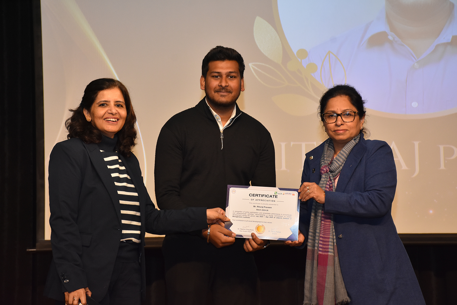 Awarding a student at the Jaipuria appreciation ceremony